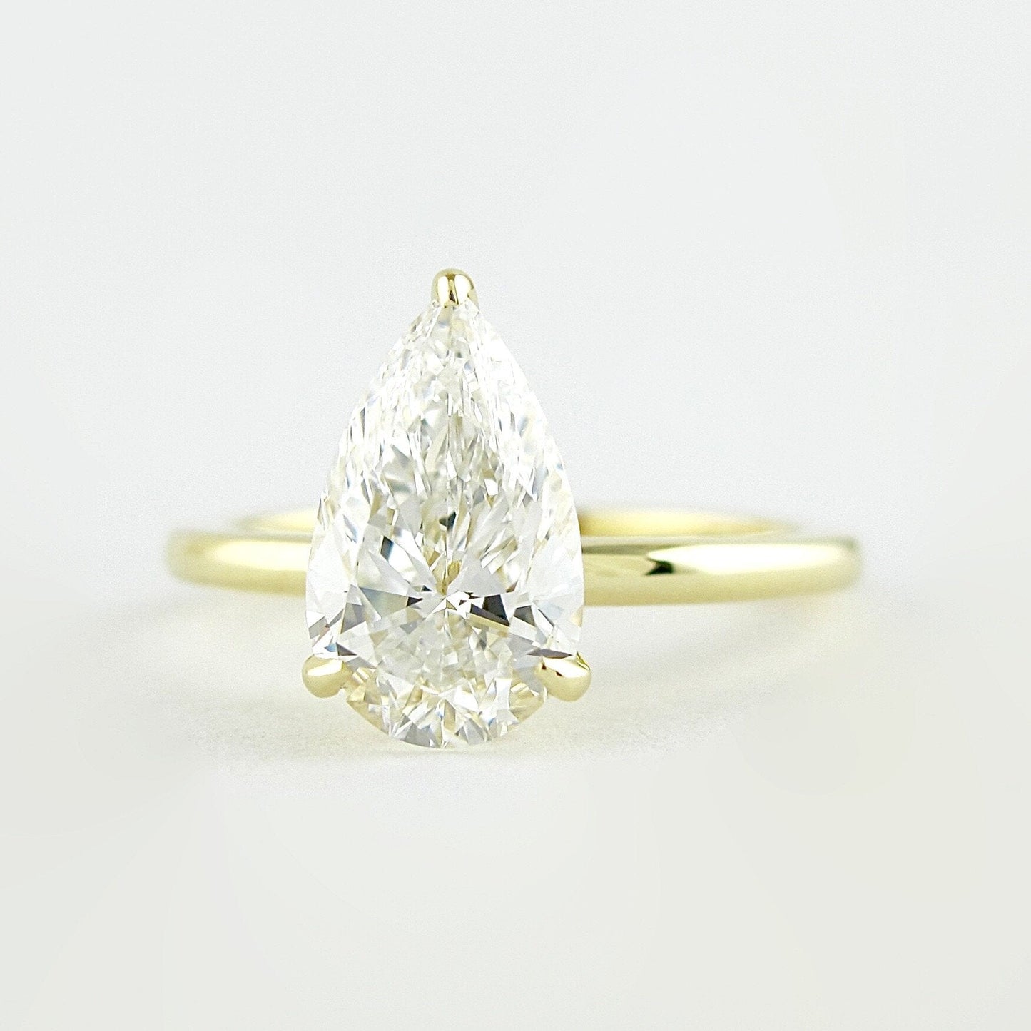 1.5 CT Pear Cut Solitaire Style Moissanite Engagement Ring 1